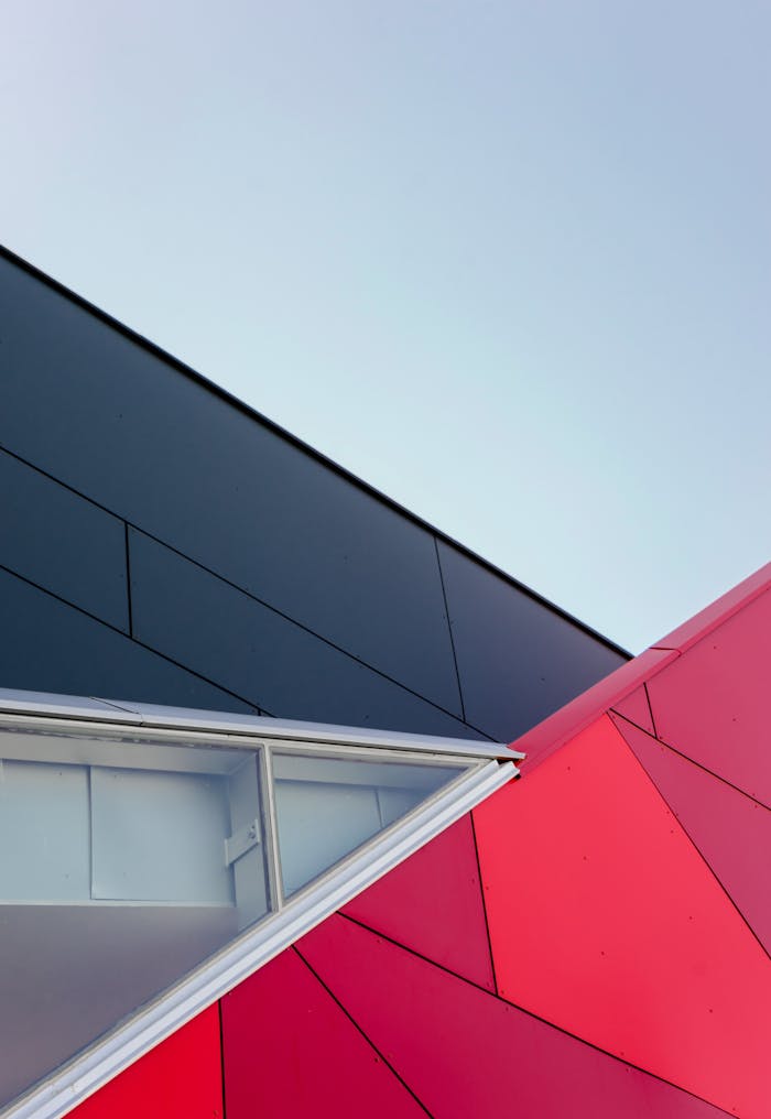 our-story A low-angle view of a modern geometric building facade with bold colors in London, ON, Canada.