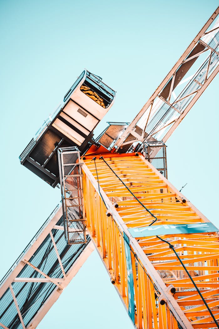 Crafting Captivating Headlines: Your awesome post title goes here A striking low angle shot of a vibrant yellow tower crane against a clear sky, showcasing industrial power.